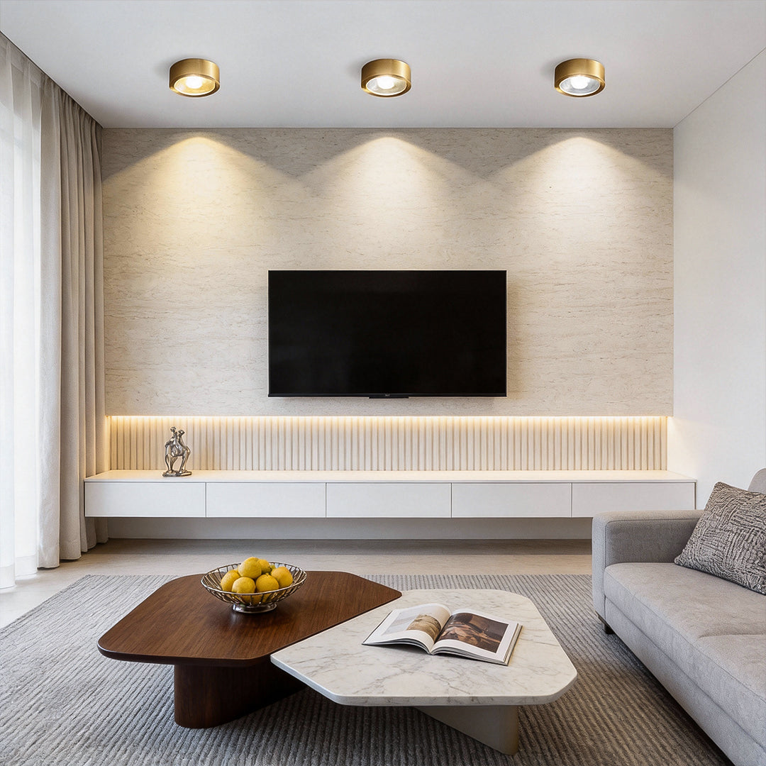 Gold LED downlights illuminating a minimalist living room with warm ambient light.