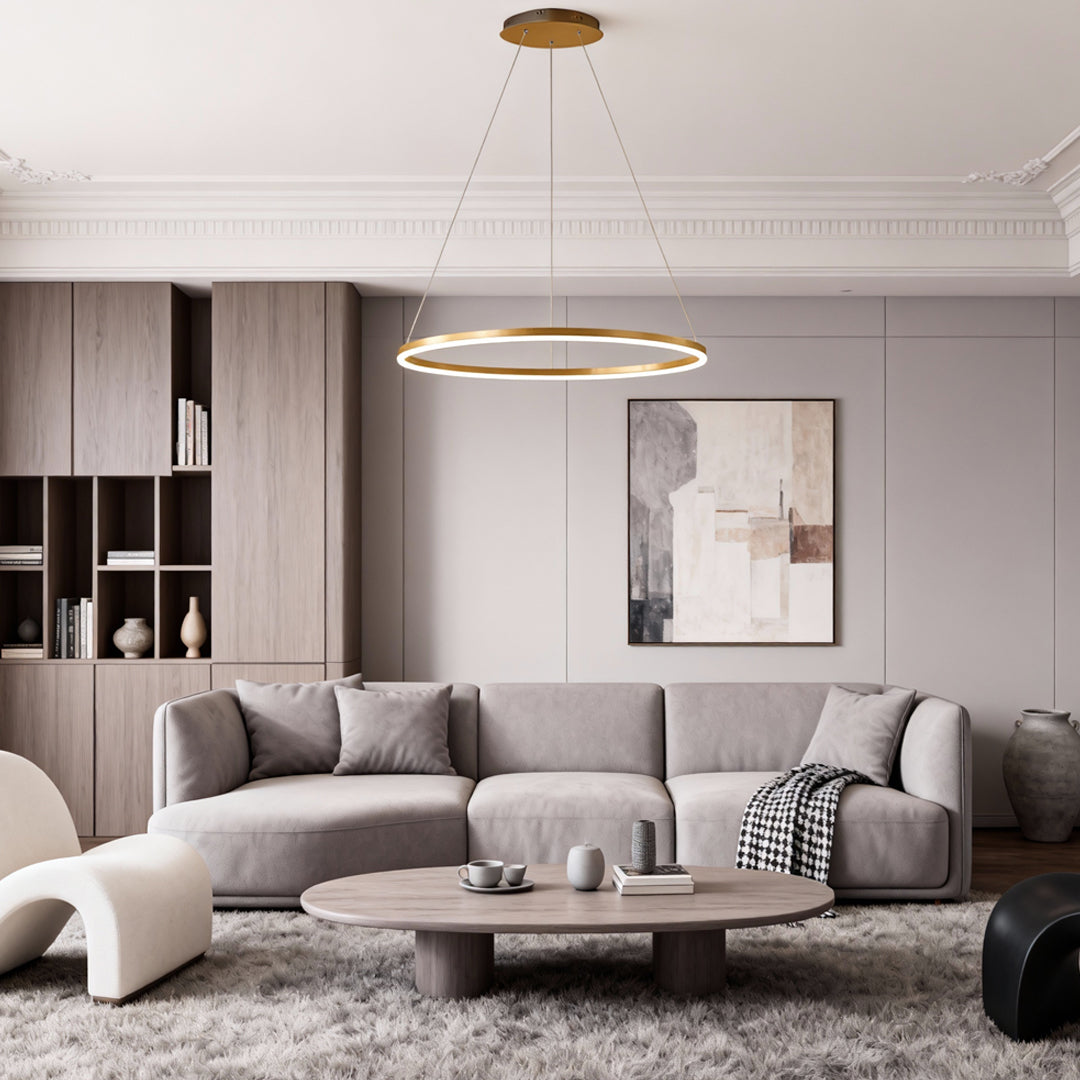 Gold LED ring chandelier mounted in a modern living room with contemporary furniture.