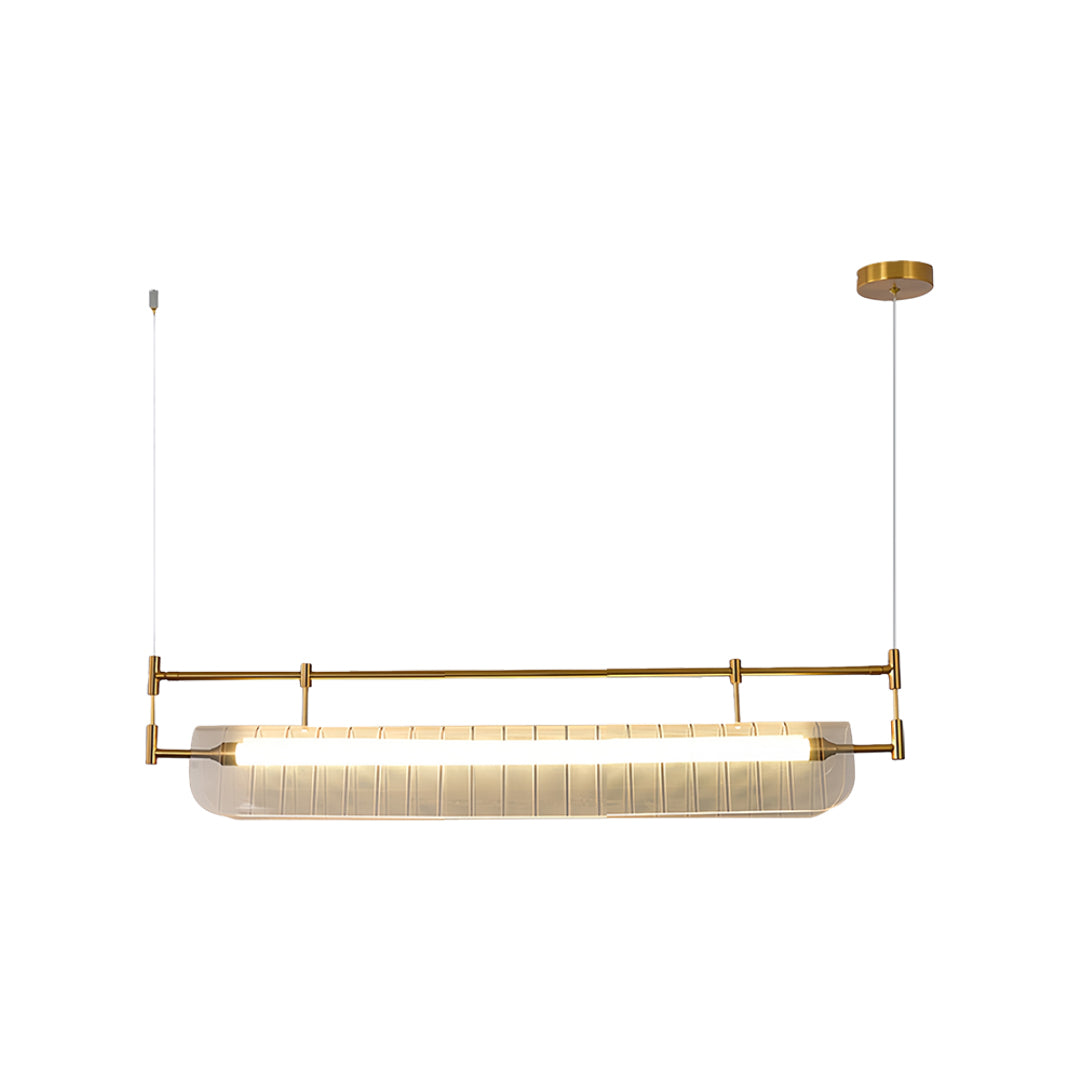 Gold linear light pendant with ribbed glass diffuser suspended by thin cables on white background