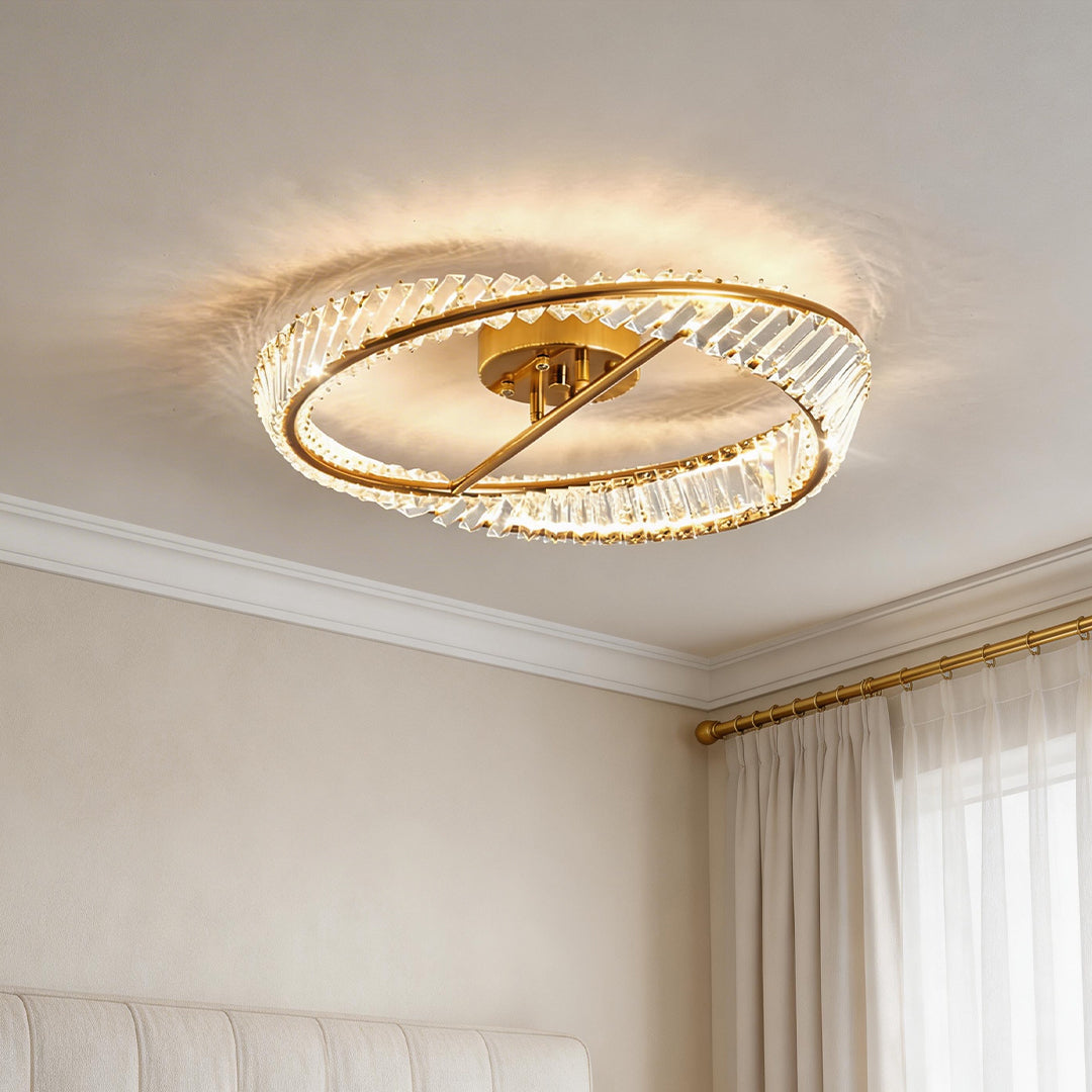 Modern gold mobius light fixture with crystal prisms and a sleek infinite loop ring design.