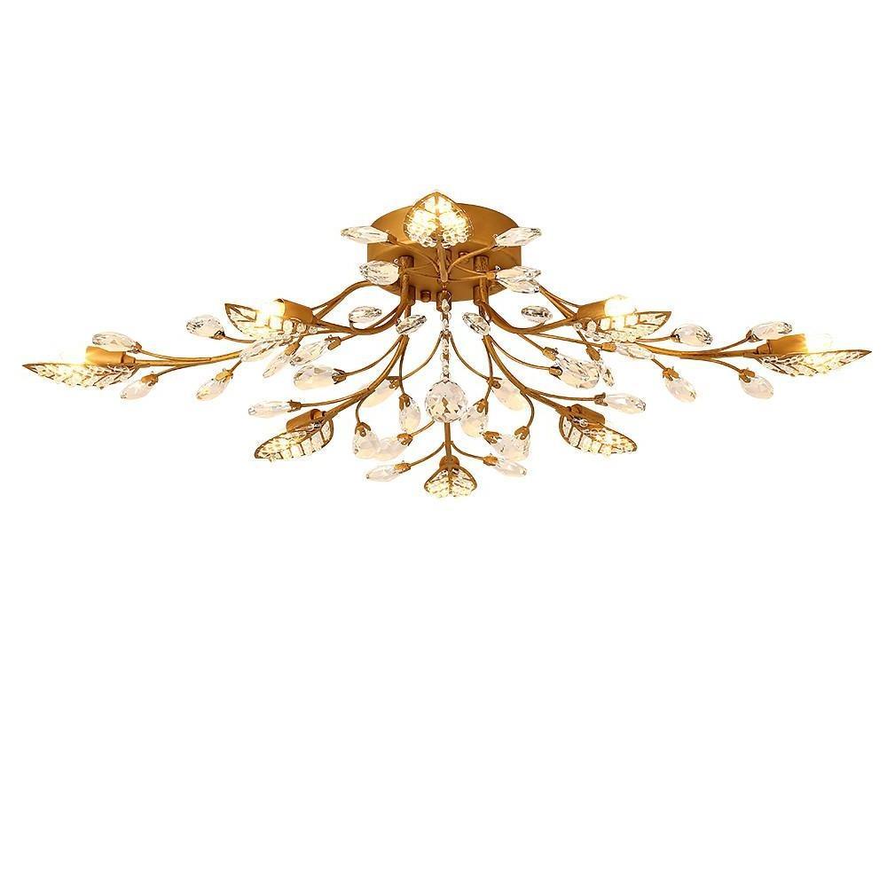 Gold modern branch chandelier isolated on a white background with leaf-inspired arms and crystal pendants.