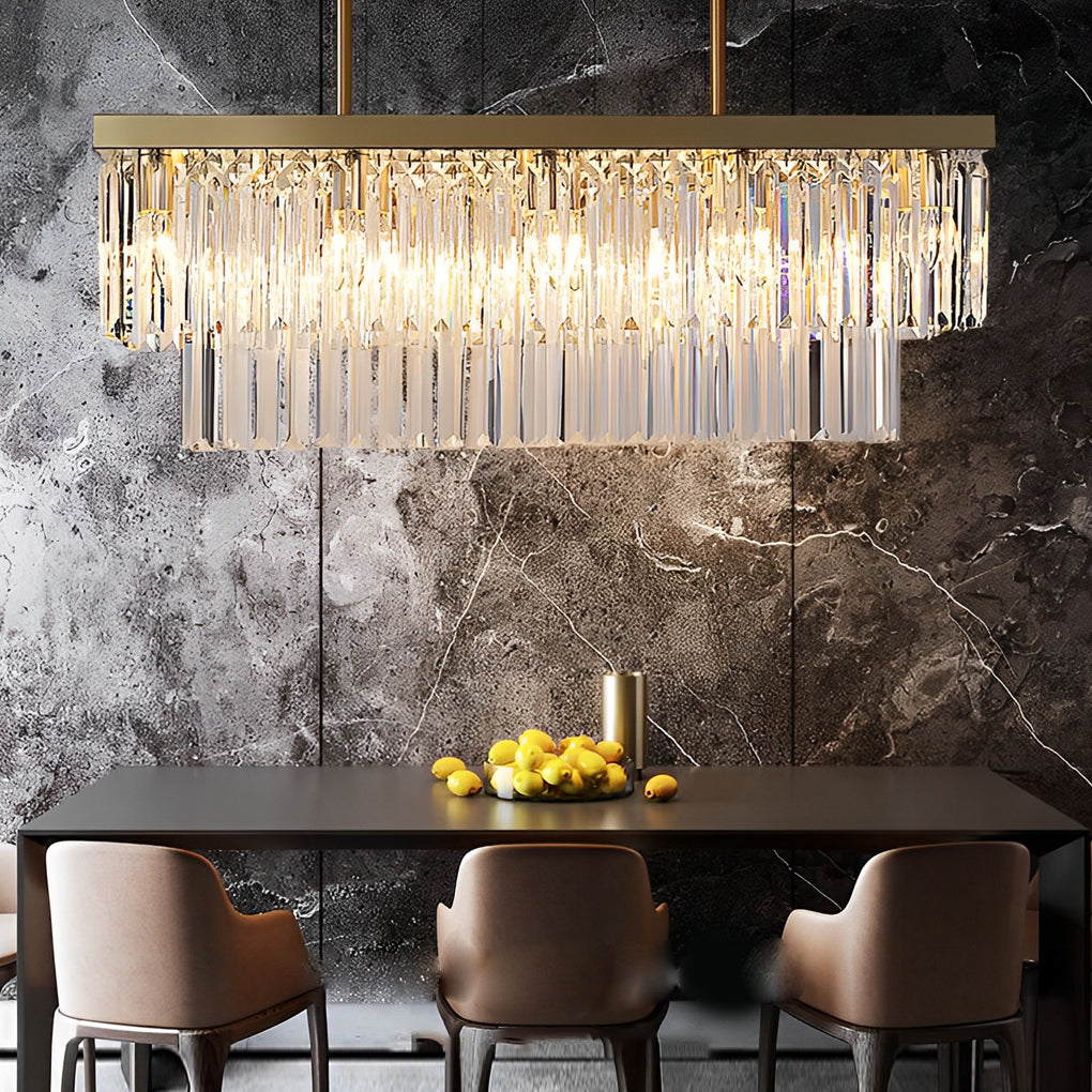 Gold rectangular chandelier with crystal details, providing warm light in a luxurious living room.