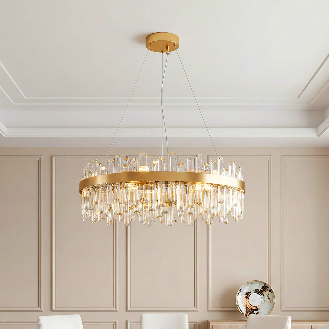 Stunning ring-shaped luxury crystal chandelier featuring a gold band and cascading clear crystal rods in an elegant paneled room.