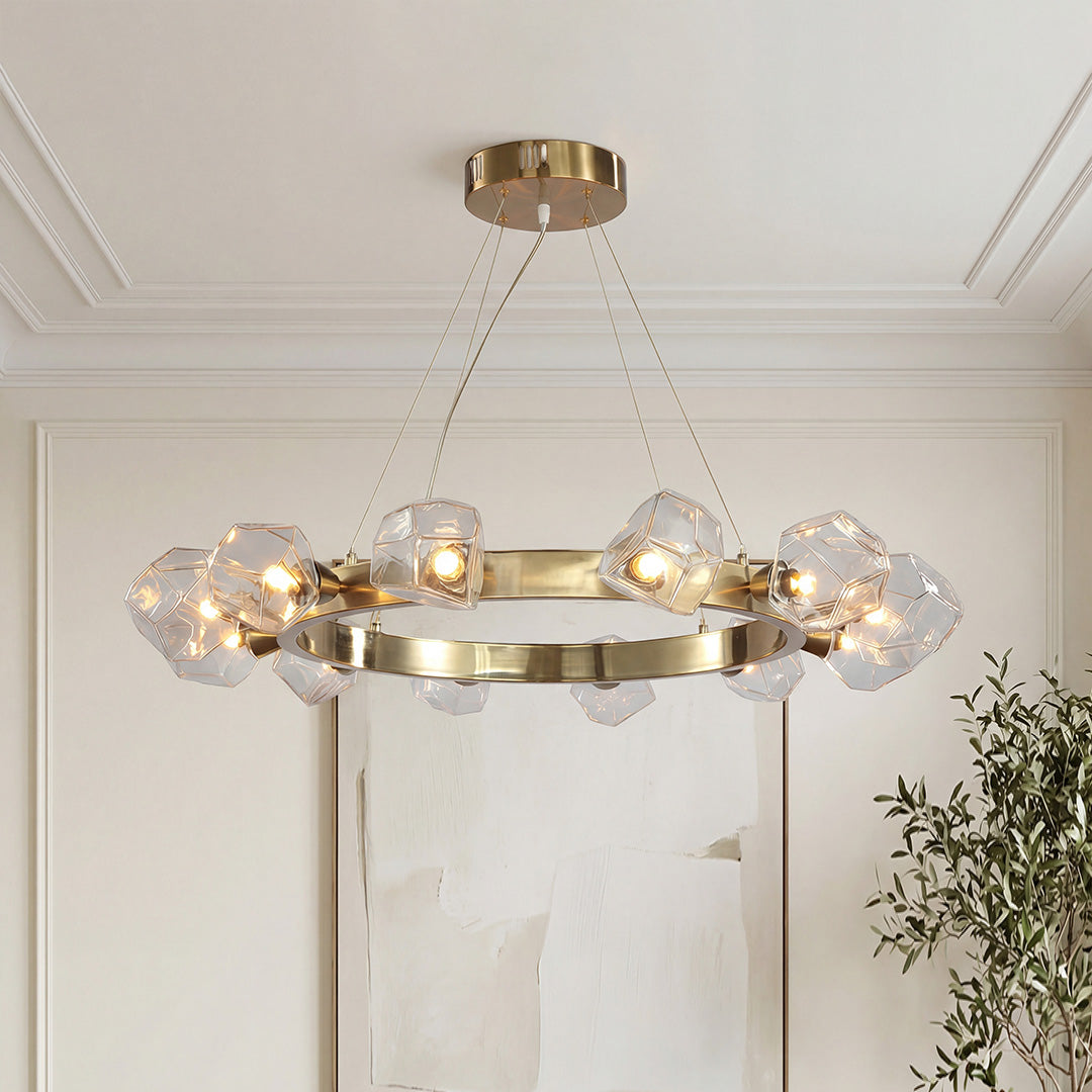 Modern gold round chandelier with geometric glass rock shades on a sleek metallic ring frame.