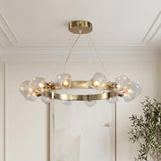 Modern gold round chandelier with geometric glass rock shades on a sleek metallic ring frame.