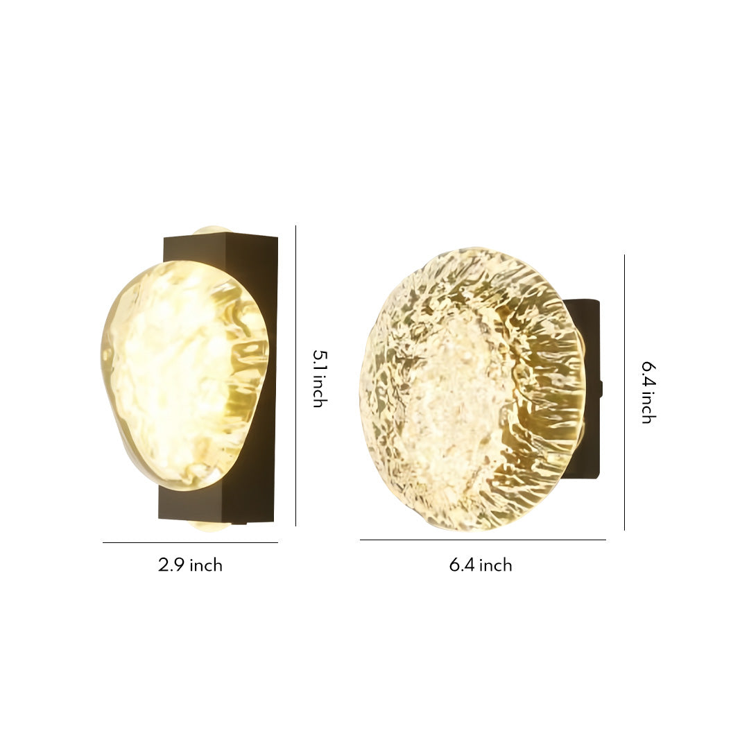 Two round textured-gold up and down outdoor wall lights displayed on a plain background with warm illuminated surface.