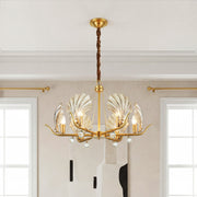 Elegant gold shell chandeliers featuring fluted glass shades and crystal teardrop accents in a sophisticated room.