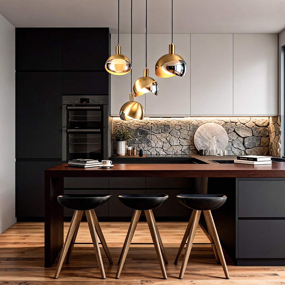 Gold sphere pendant light trio suspended over a kitchen island with modern cabinetry.