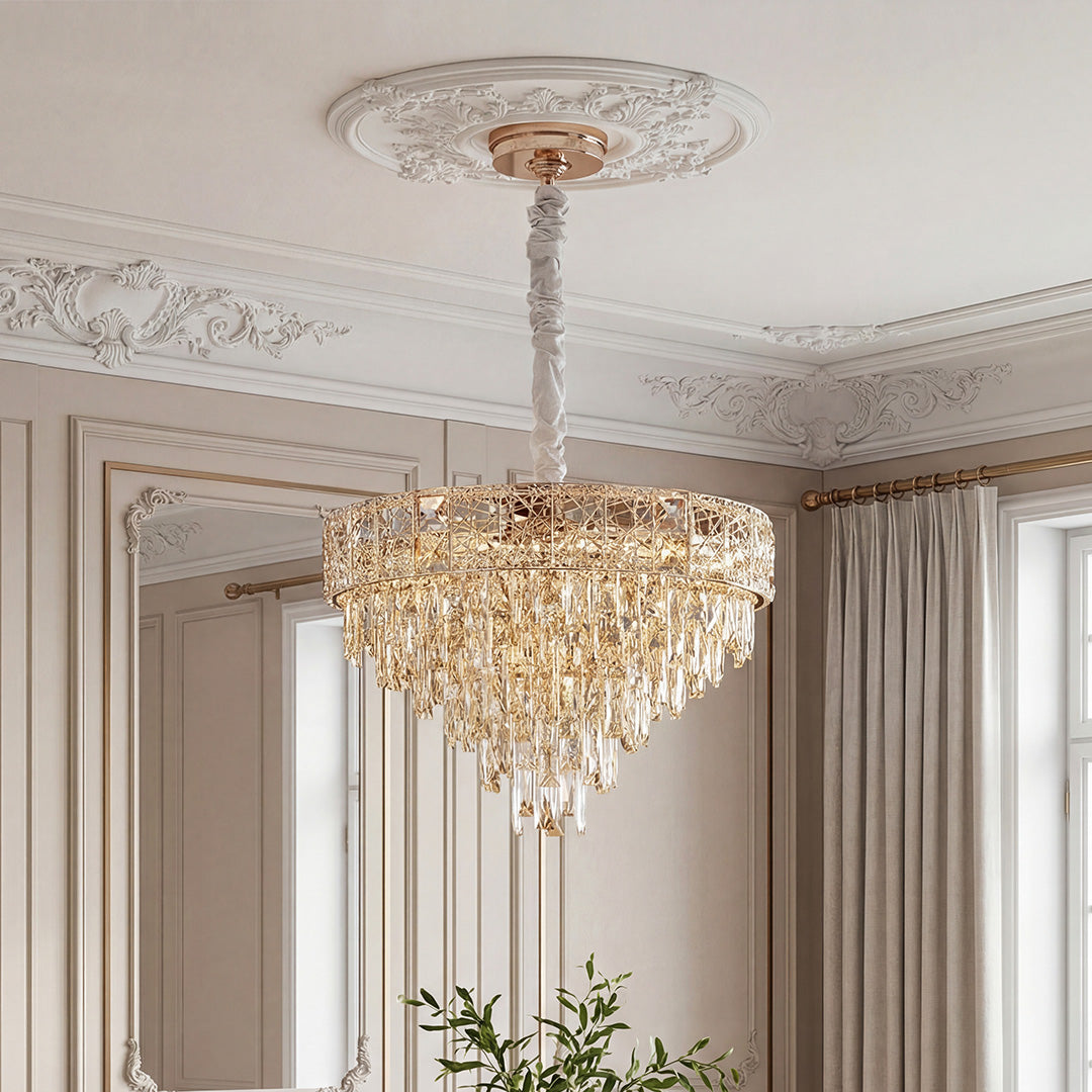 Elegant gold fixture featuring cascading large chandelier crystals in a tiered teardrop design, suspended from an ornate ceiling medallion.