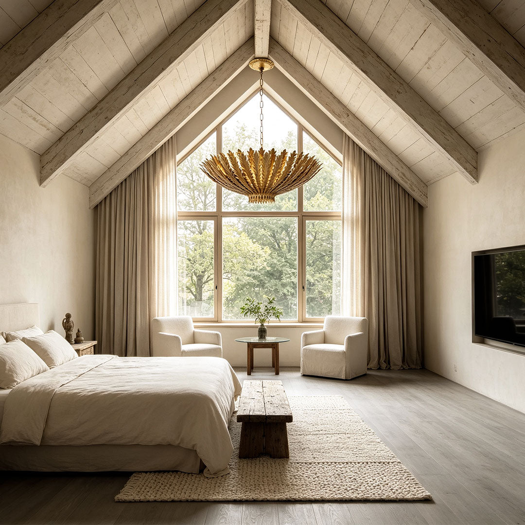 Gold vintage chandelier illuminating a rustic luxury bedroom with exposed wooden ceiling beams.
