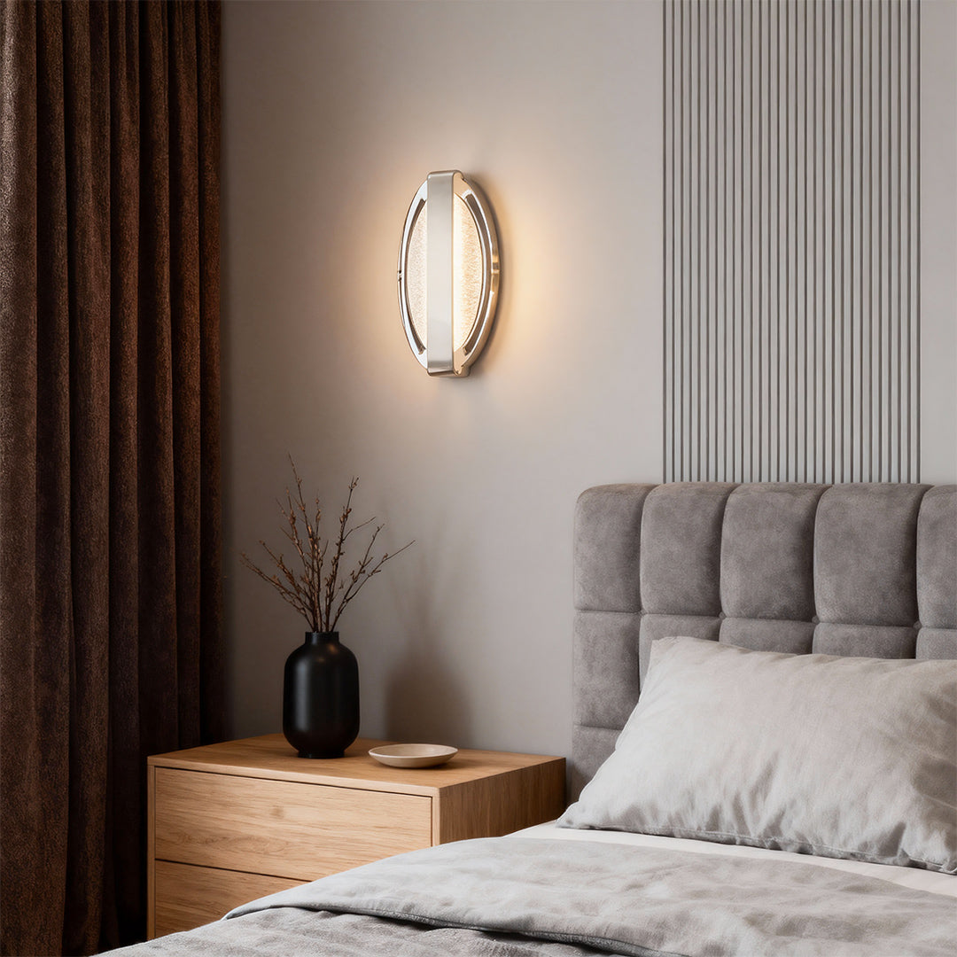 Gold wall lights mounted in bedroom beside gray upholstered bed creating warm ambient illumination