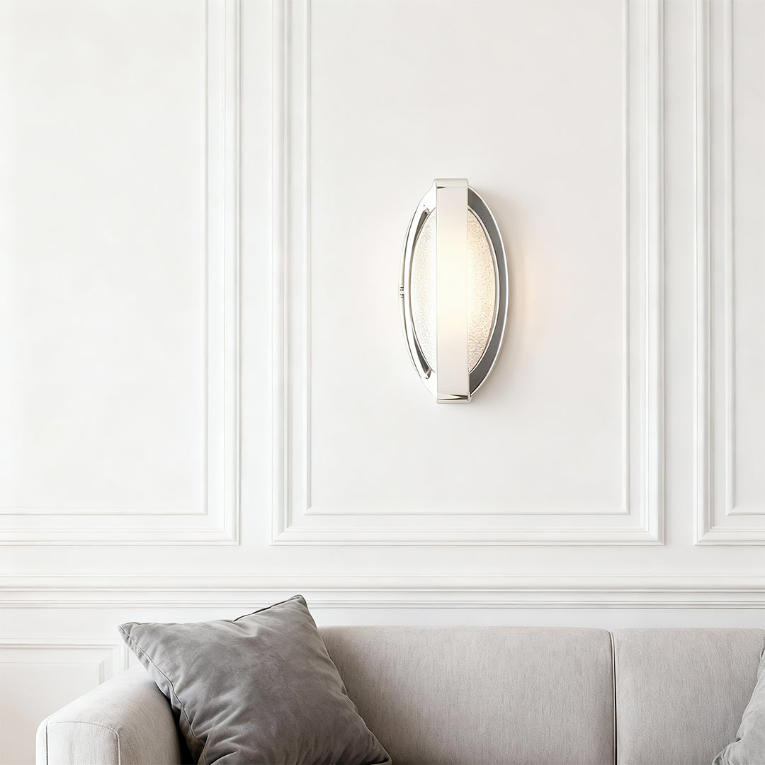 Gold wall lights providing elegant accent lighting on white paneled wall in classic interior setting