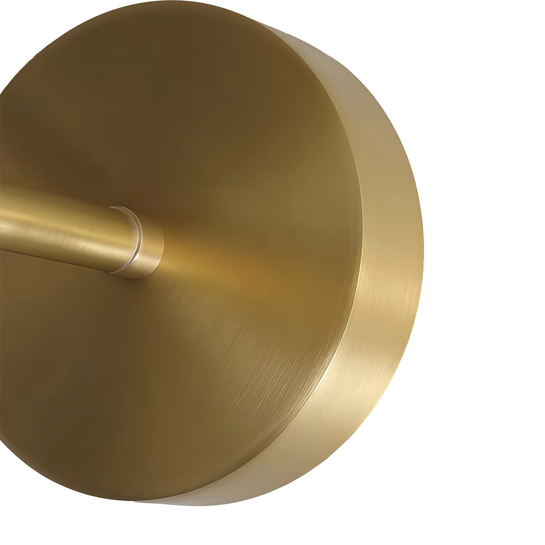 High resolution detail of the gold wall sconce lighting finish on a circular metallic base.