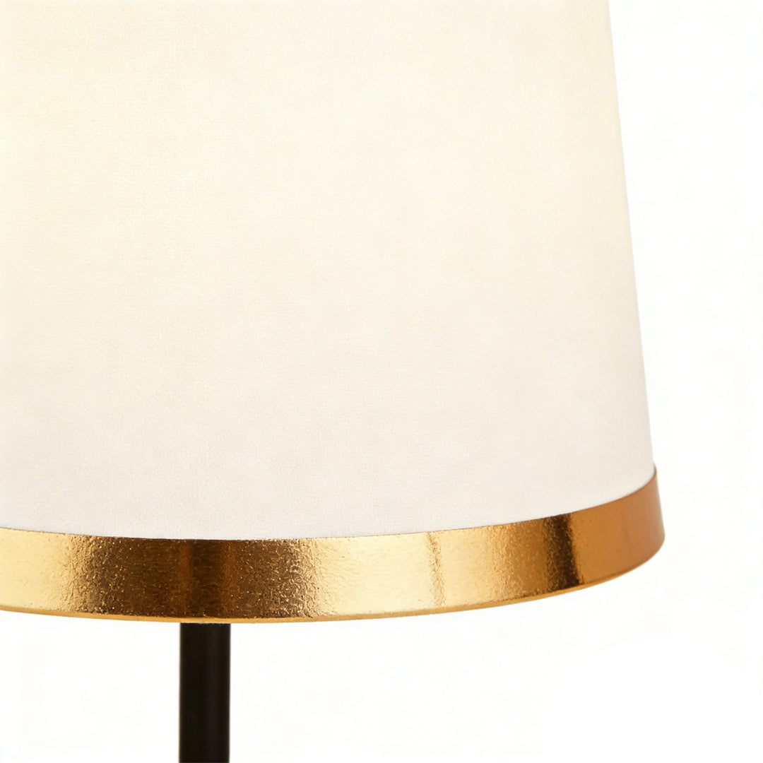 Gold white table lamp with a close-up of its gold base and white shade detail.