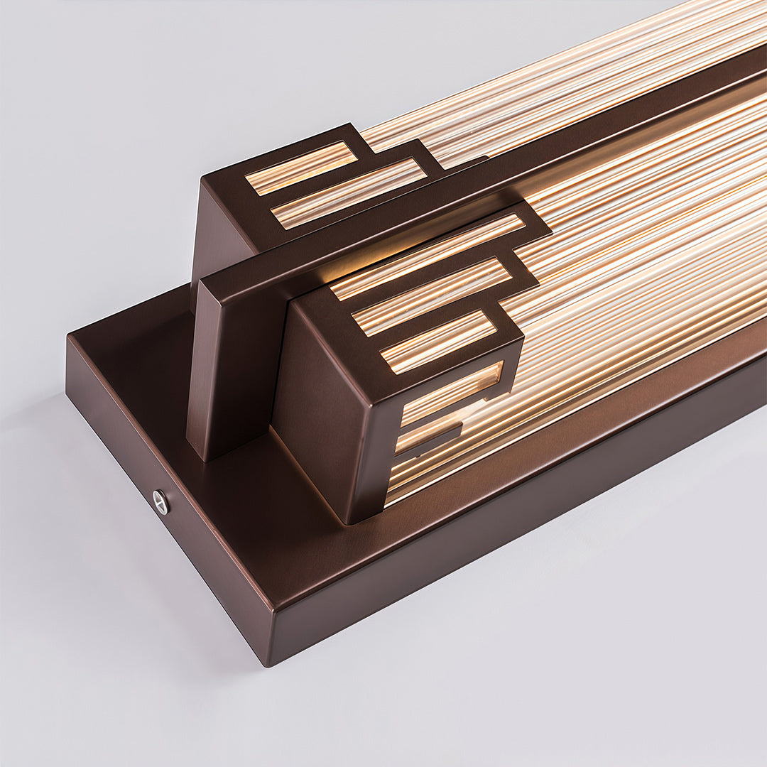 Golden LED outdoor wall light mounted beside the front door, adding a decorative touch to the entrance.