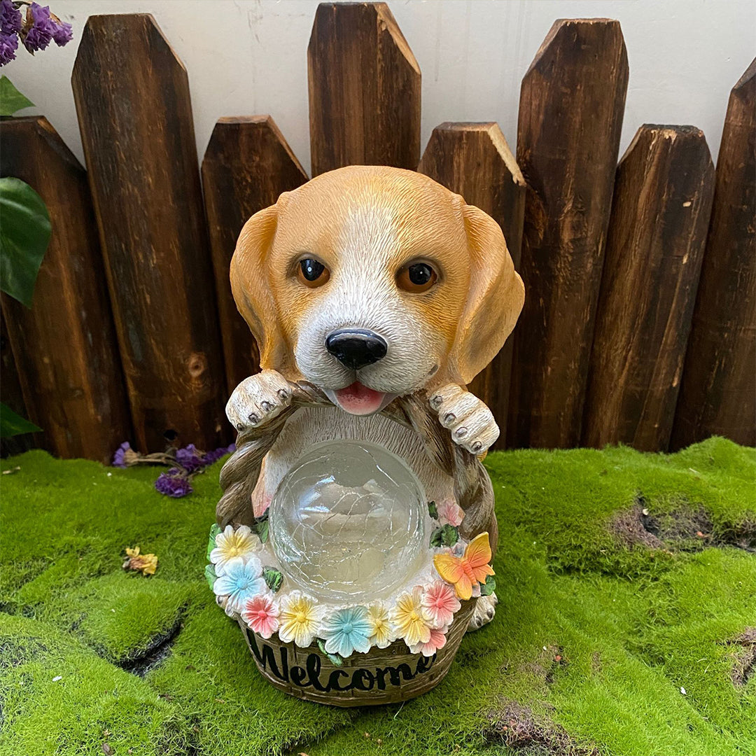 Golden retriever puppy figurine with glowing welcome basket positioned on moss near wooden fence