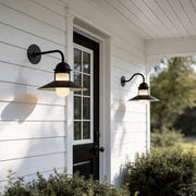 Gooseneck wall light fixtures with a classic black design, illuminating a white house exterior.