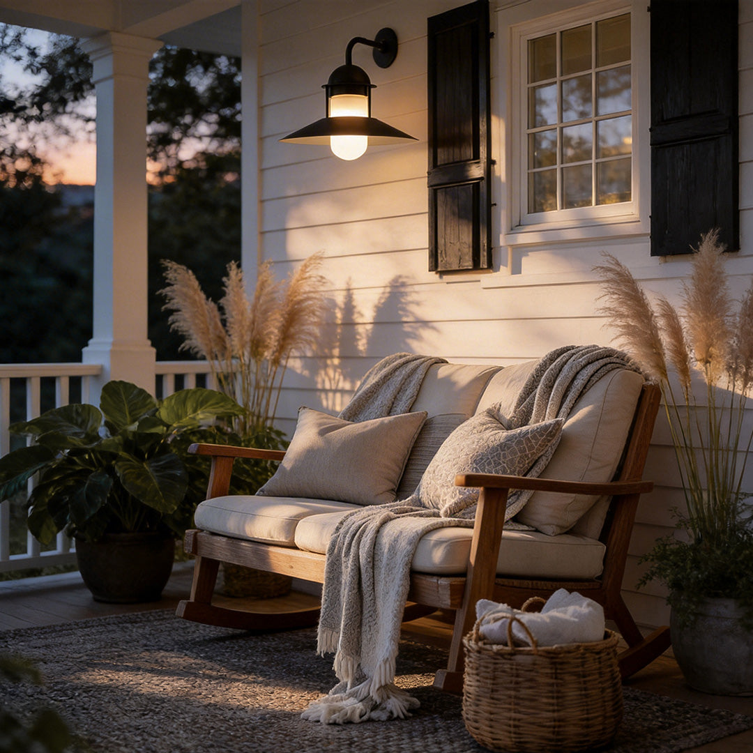 Gooseneck wall light fixtures providing warm illumination on a cozy porch seating area.