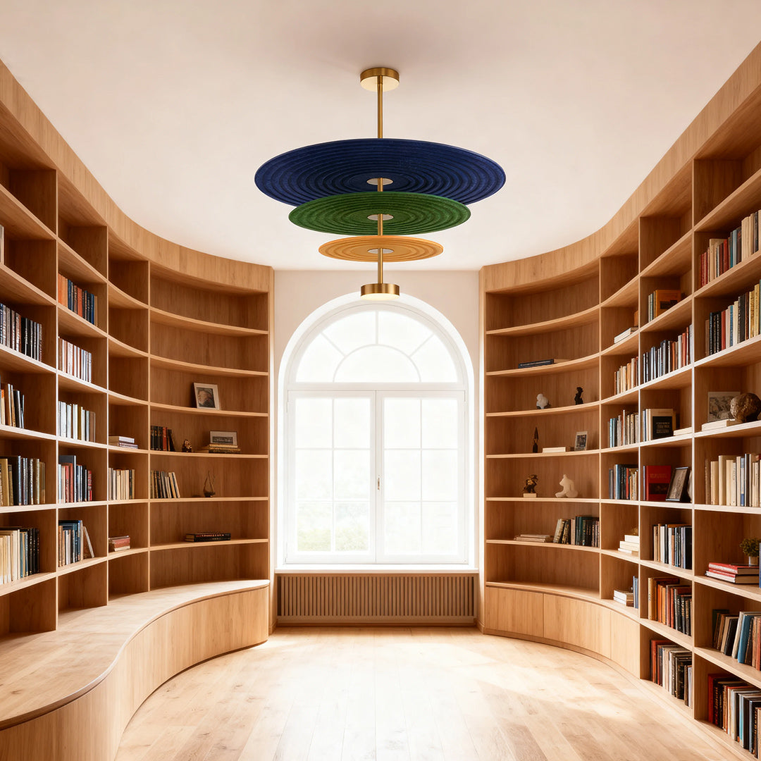 Grand 3 tier chandelier with blue and green felt shades suspended in a luxurious, curved wooden home library with a large window.