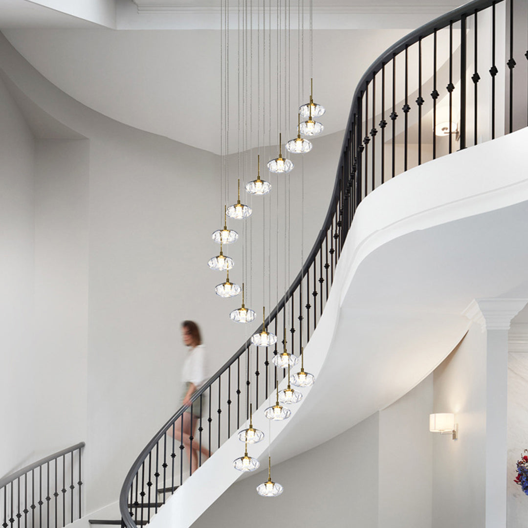 Elegant chandelier for tall ceilings providing ambient lighting in grand hallway with multiple glass orb pendants