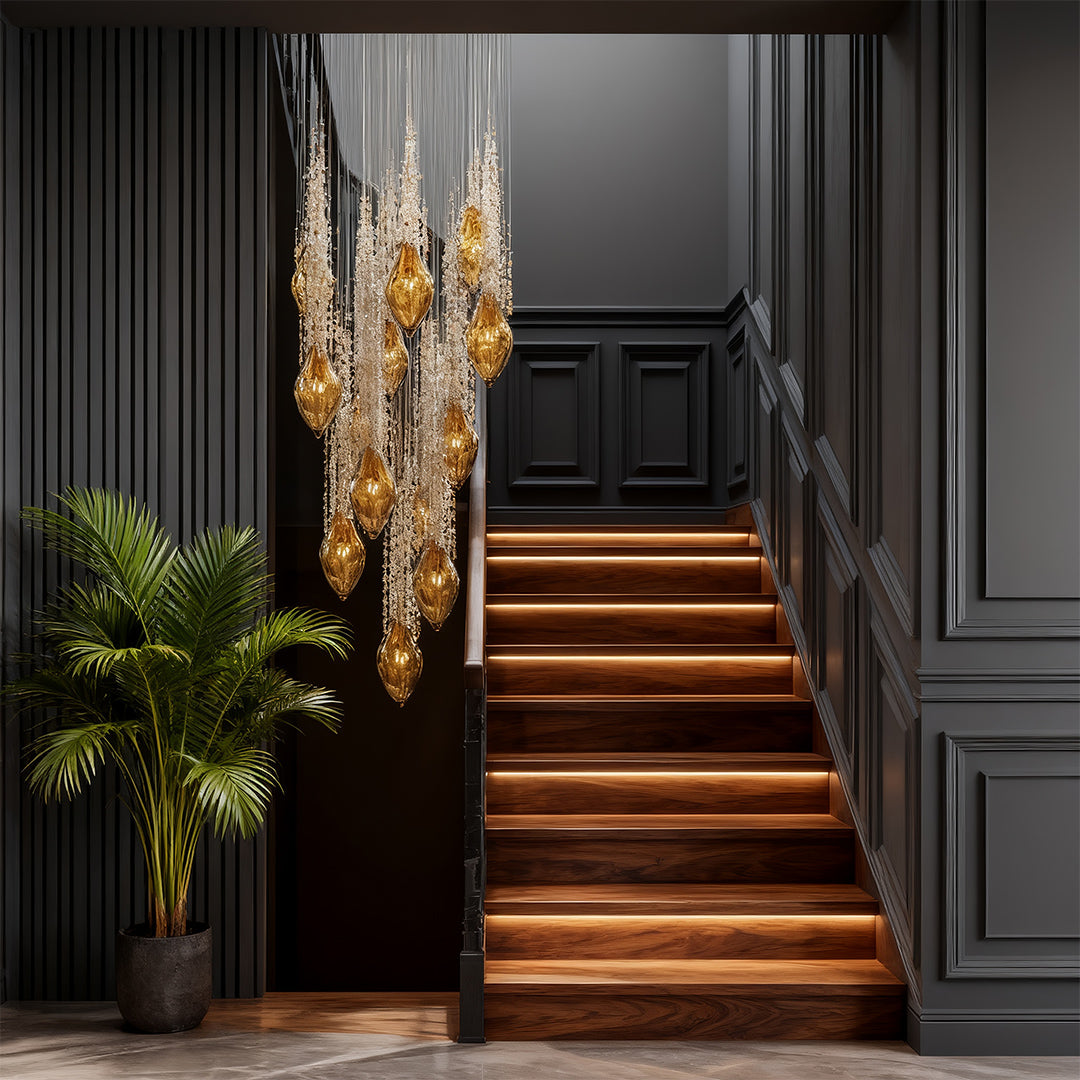 Tall stairway chandelier cascading above stairs with warm crystal glow.
