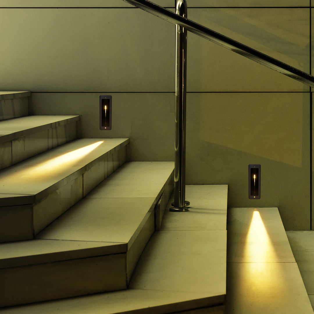 Gray rectangular recessed fixture with black interior and vertical LED strip for directional lighting