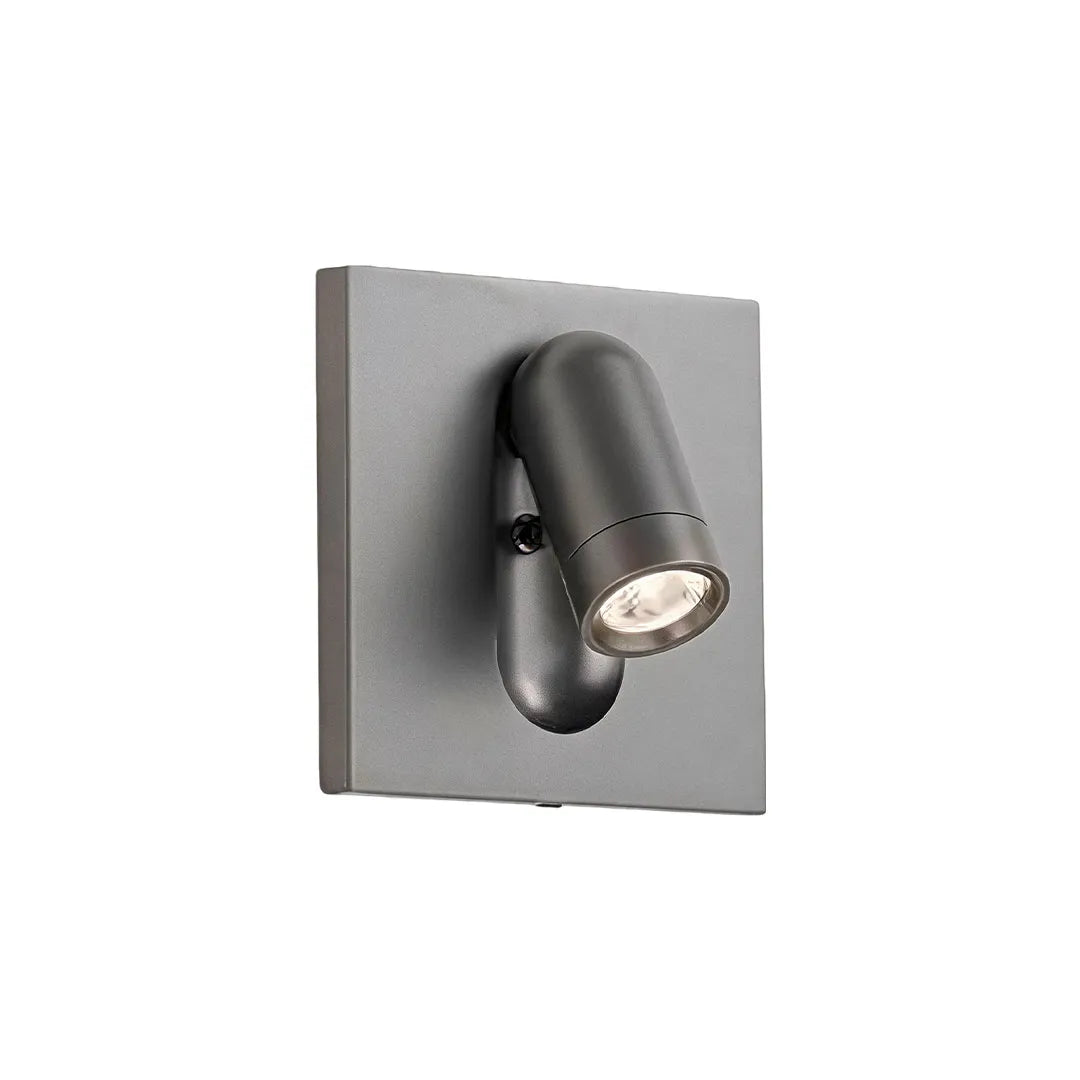 Gray wall mounted LED reading light featuring an adjustable cylindrical spotlight head.