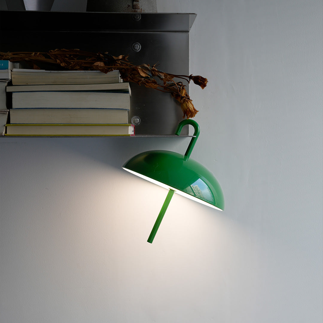 Green clamp-style USB rechargeable table lamp mounted for adjustable task lighting