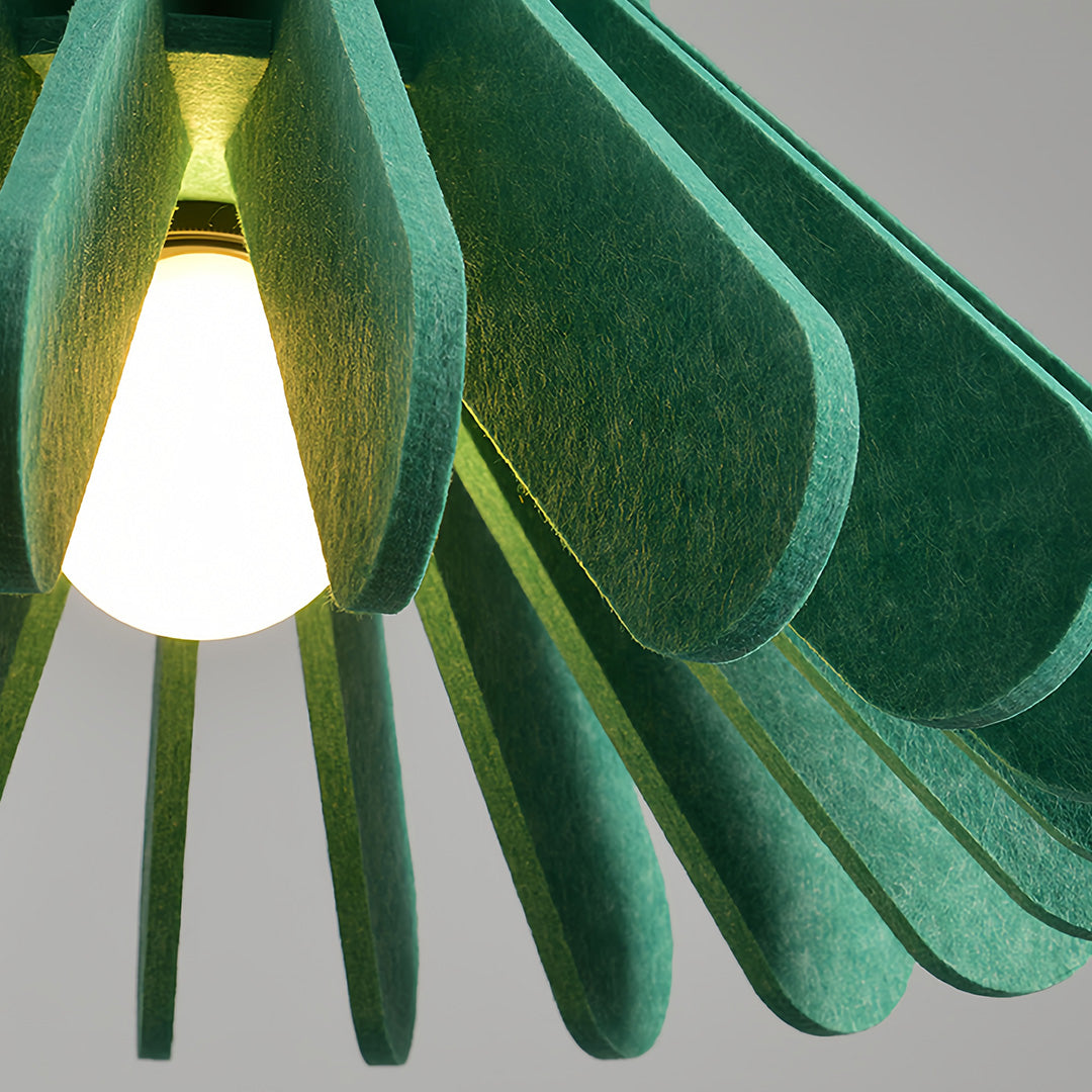 Close-up view of the green felt petal shade of a tiny pendant light with exposed bulb 