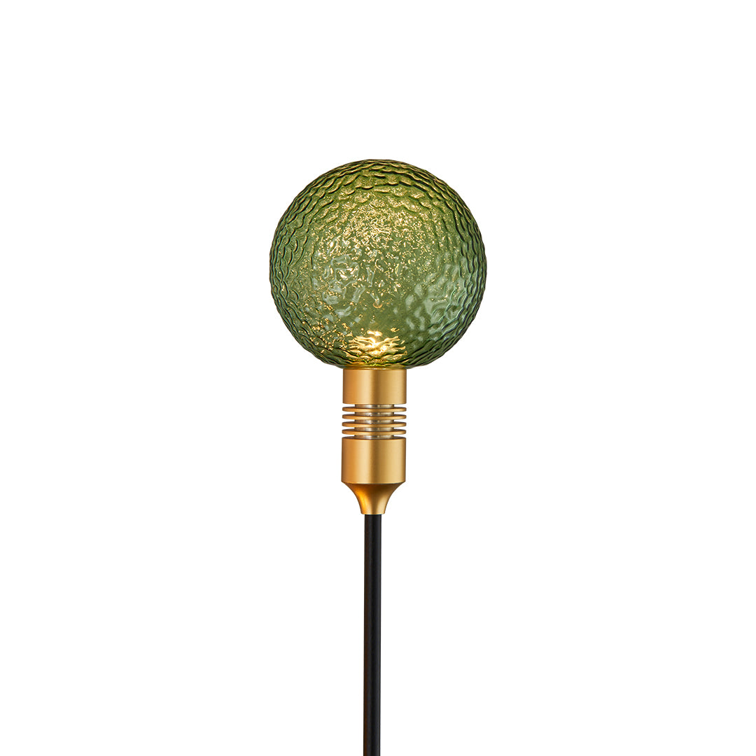 Green textured glass sphere on a garden stake designed for natural-inspired path landscape lighting.