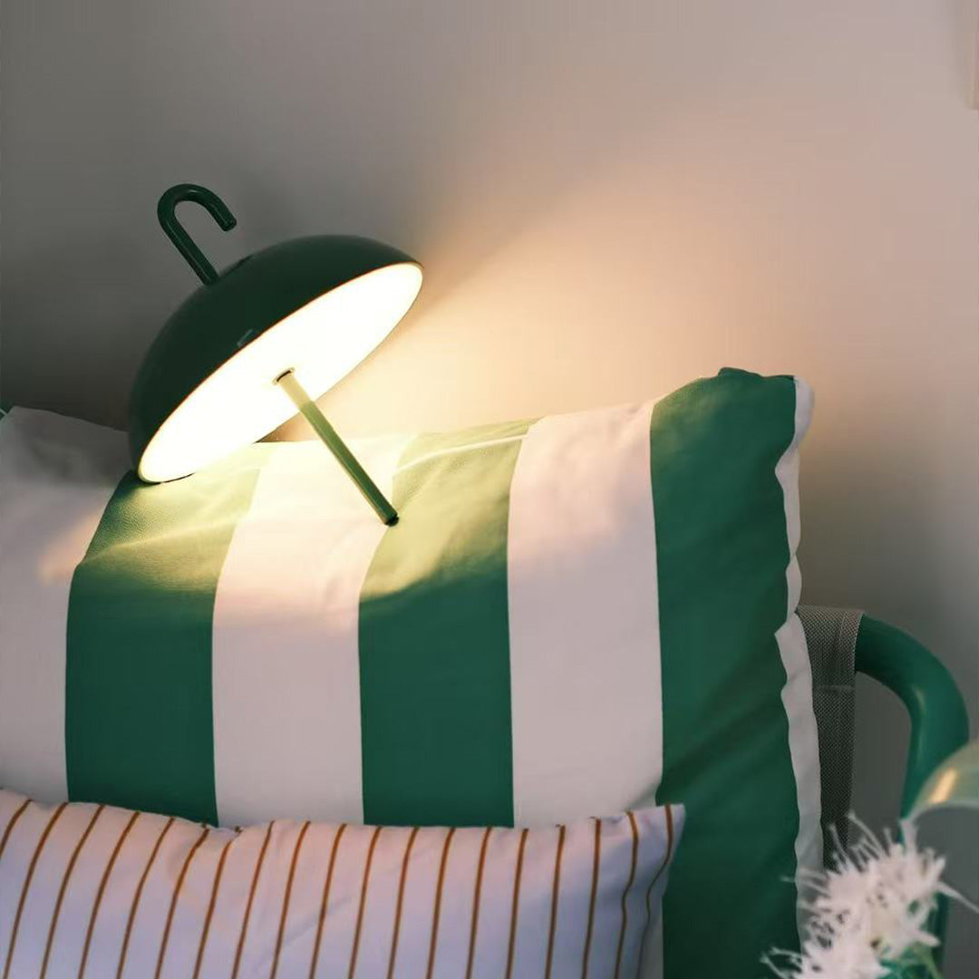 Green USB rechargeable table lamp providing accent lighting in contemporary workspace