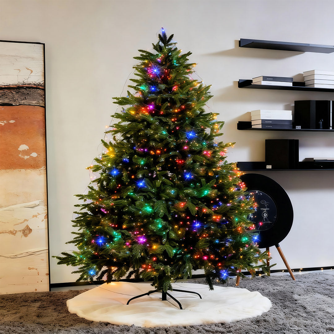 Indoor Christmas tree decorated with multicolor green-wire string lights.