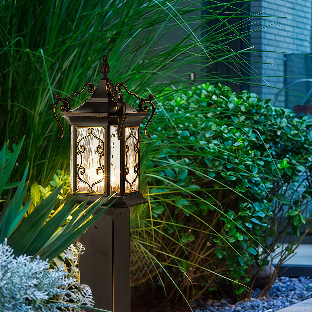 Landscape post lights placed among lush greenery, adding soft and inviting outdoor lighting.