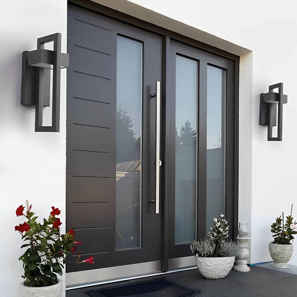 Grey black outdoor wall sconce modern installed on a minimalist concrete surface.