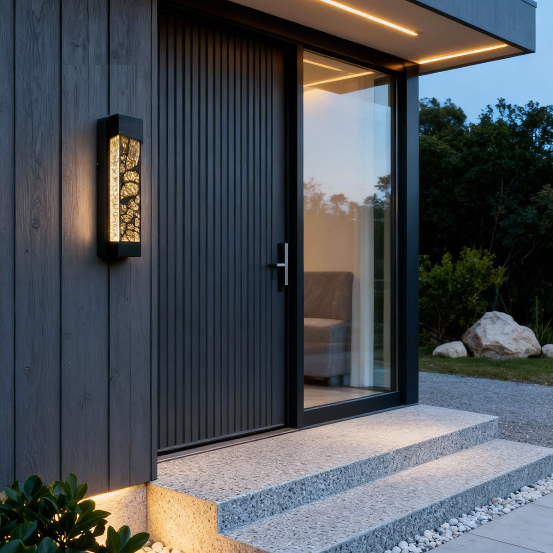 Tall black led linear wall light mounted on a grey modern exterior wall, adding stylish accent illumination.