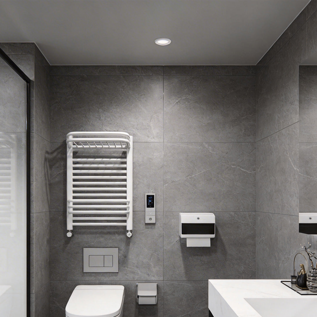 Modern toilet space illuminated by waterproof recessed ceiling spotlights with grey tiles.