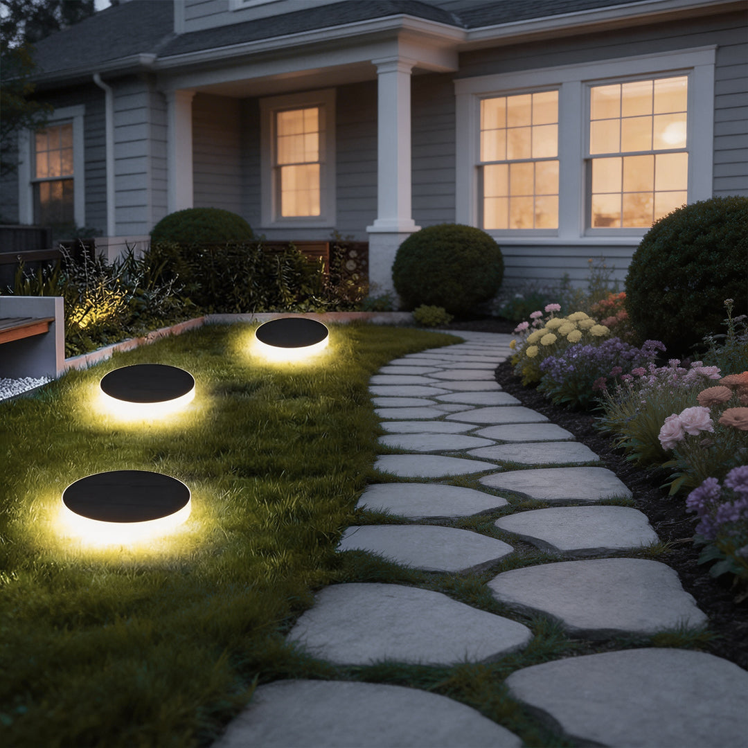 Ground solar lights enhancing a contemporary house entrance with elegant ambient light.