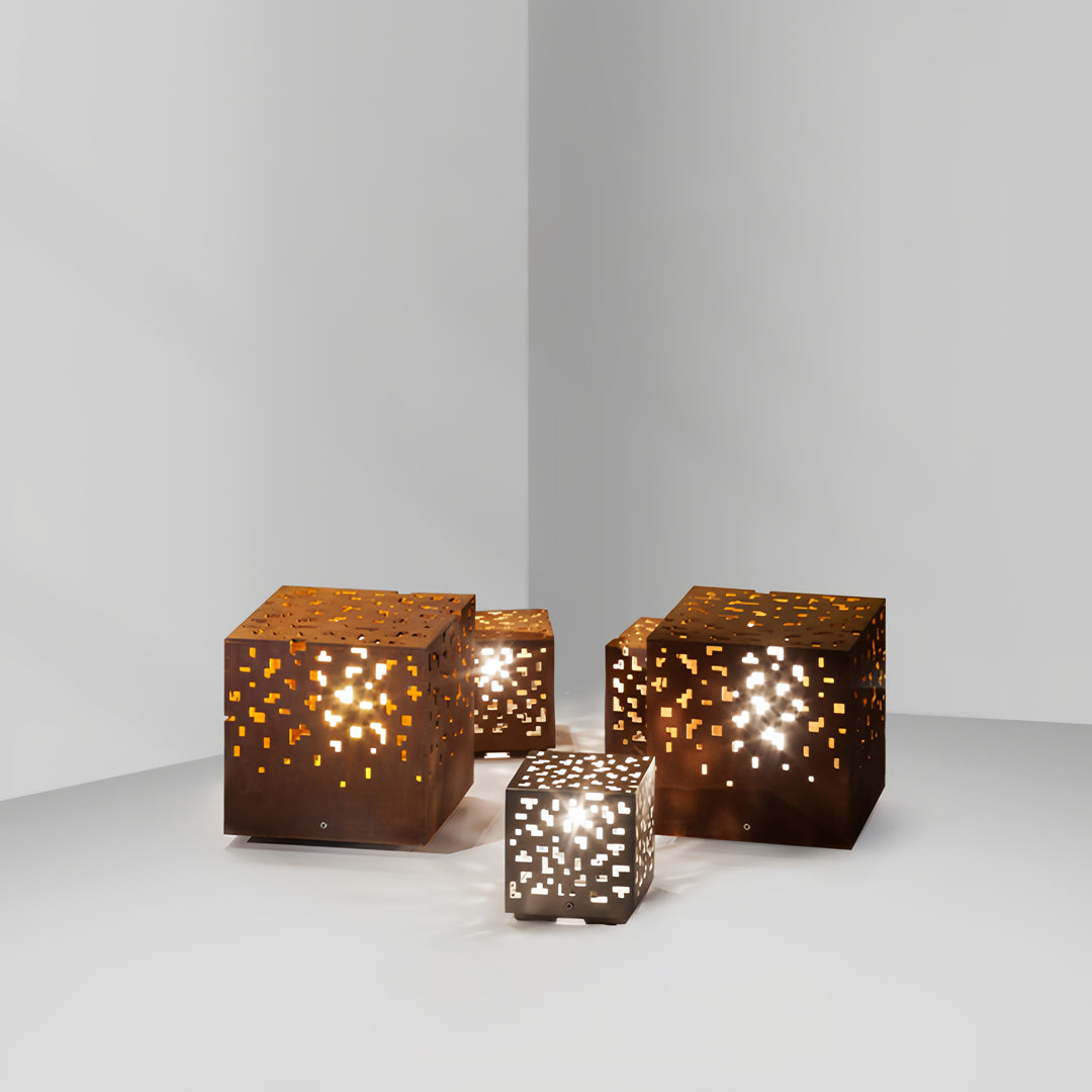 Decorative black outdoor lantern lights grouped together indoors, showcasing perforated light projection effects.