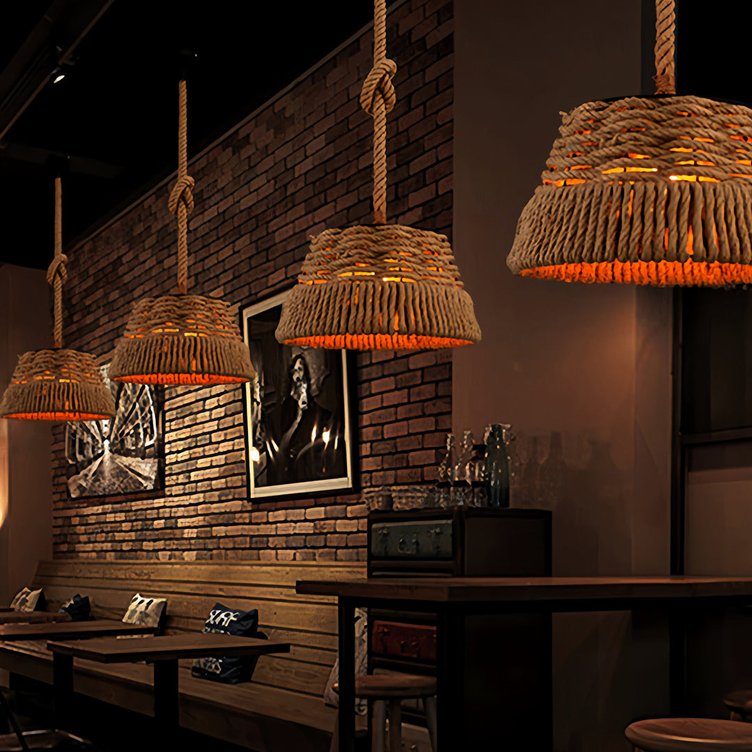 Group of unique basket-style rope pendant lights providing ambient lighting in a stylish, dimly lit restaurant interior.