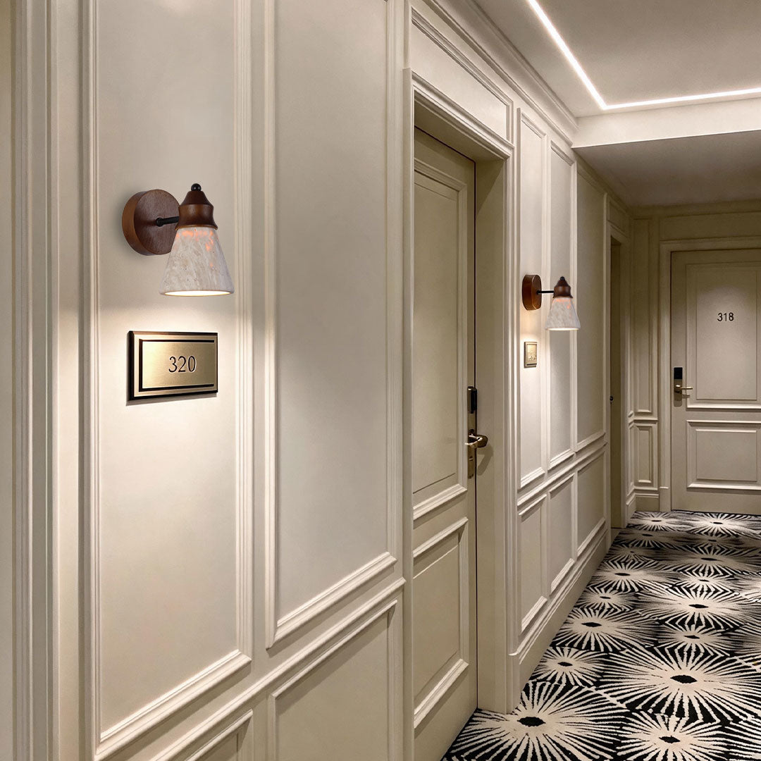 Down light wall sconce installed along an elegant hallway with warm decorative illumination.