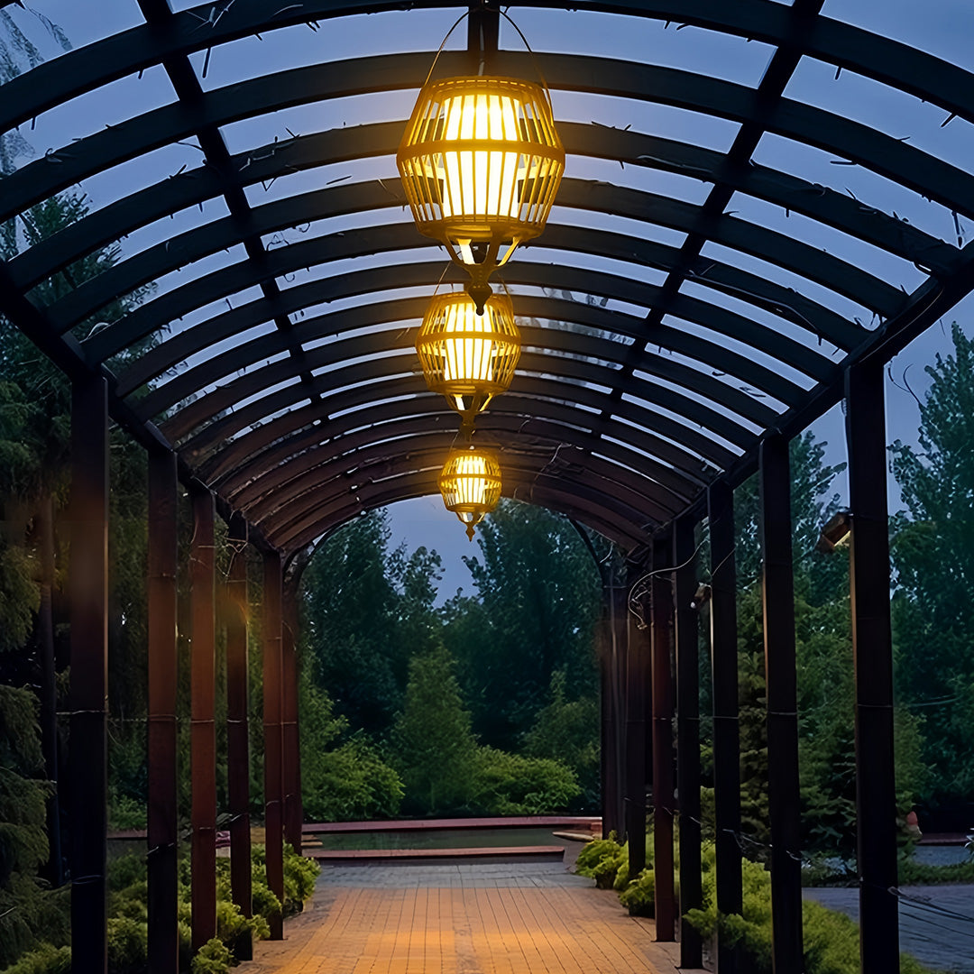 Warm glow from the handcrafted japanese lantern pendant light creating an inviting atmosphere in a garden walkway tunnel.