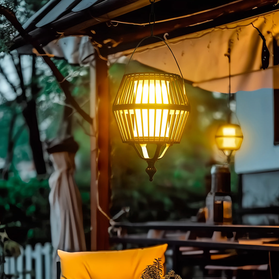 Close-up view of the handcrafted rattan japanese lantern pendant light illuminating an outdoor dining spot at night.