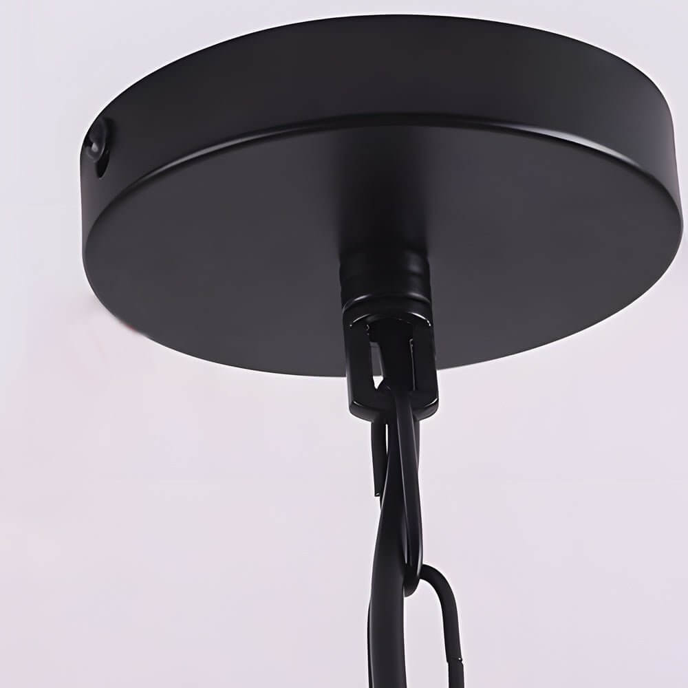 Hanging greenery with lights decorating a modern living room with large windows.