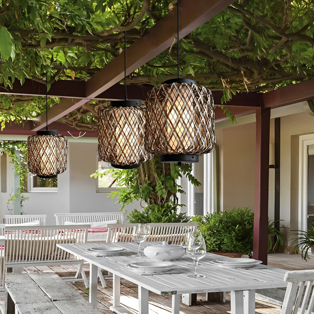 Hanging lantern lamp illuminating outdoor seating area with greenery.