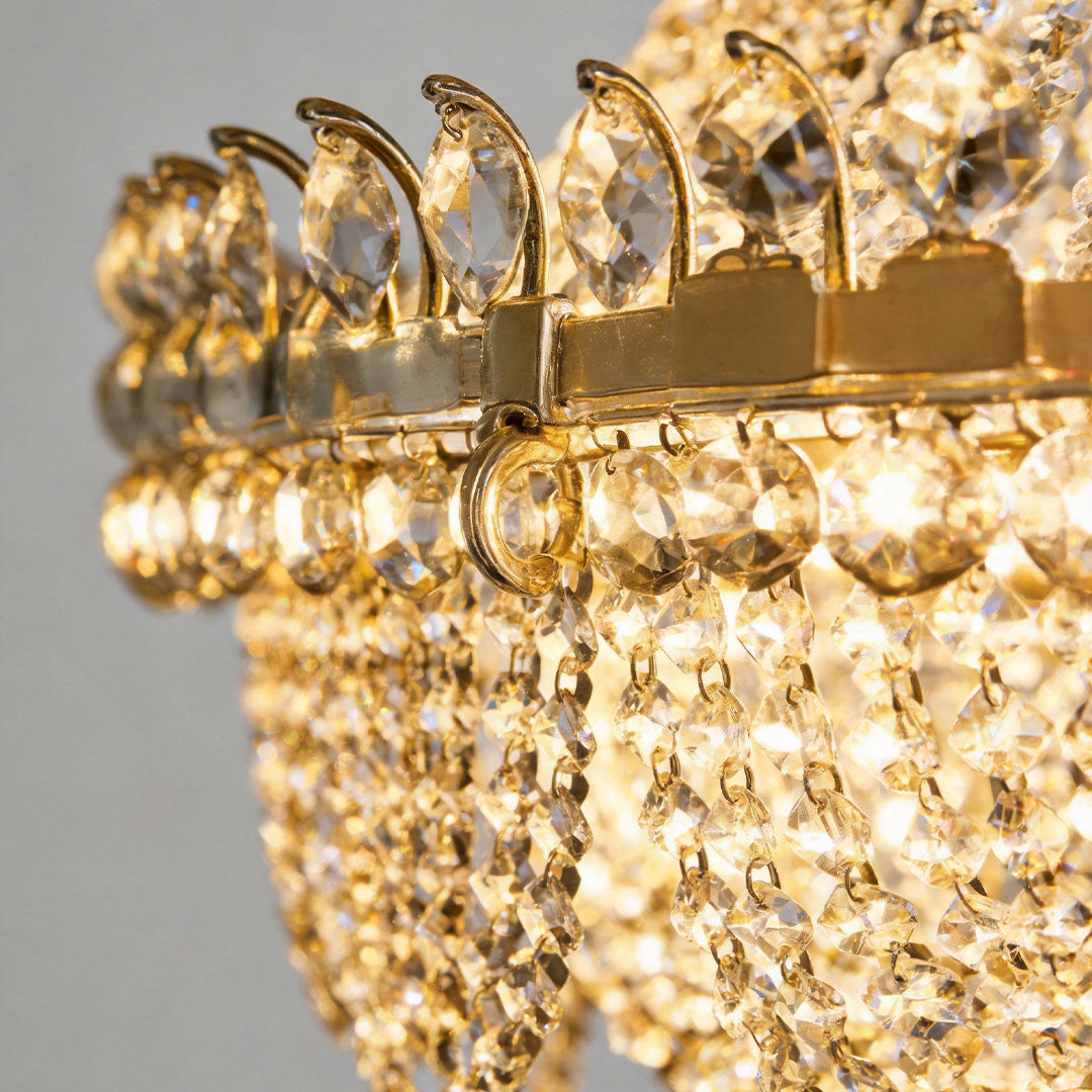 Close-up of hanging light outdoor showcasing crystal and gold details.