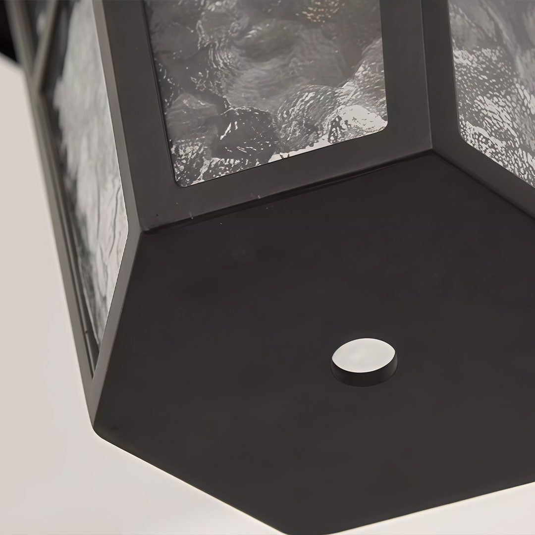 Hanging outdoor light with a black finish, suspended by a chain.