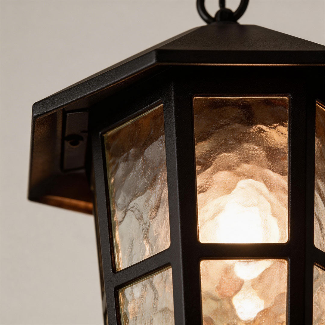 Close-up of hanging outdoor light showcasing its frosted glass panels.