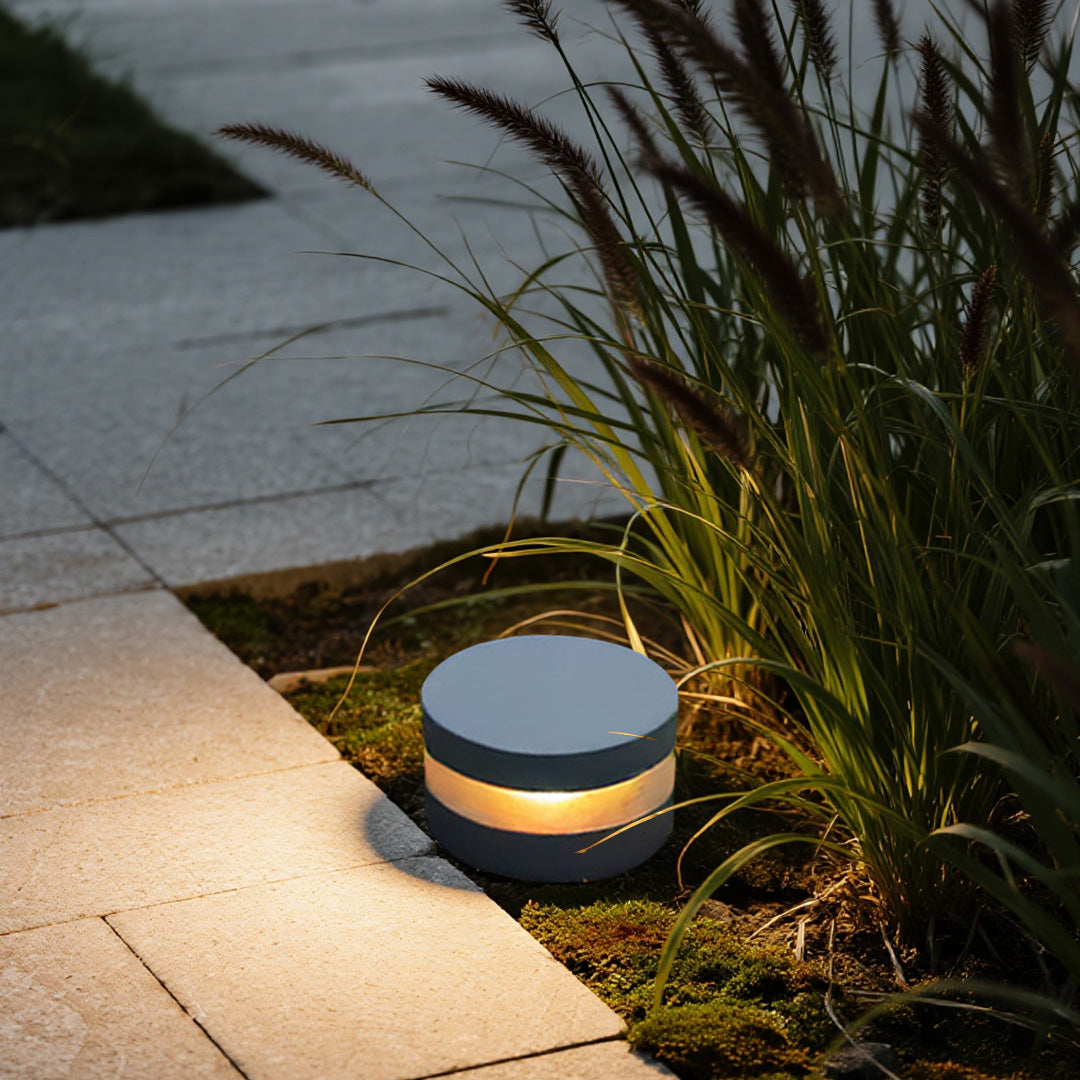 110v landscape light providing gentle accent lighting among decorative plants and modern hardscape features