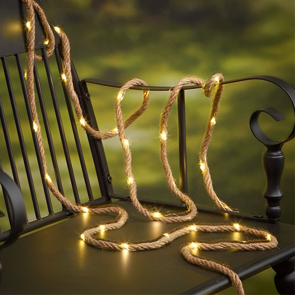 A beautiful display of hemp rope light wrapped around the railing of a porch, adding a rustic touch to the outdoor decor.
