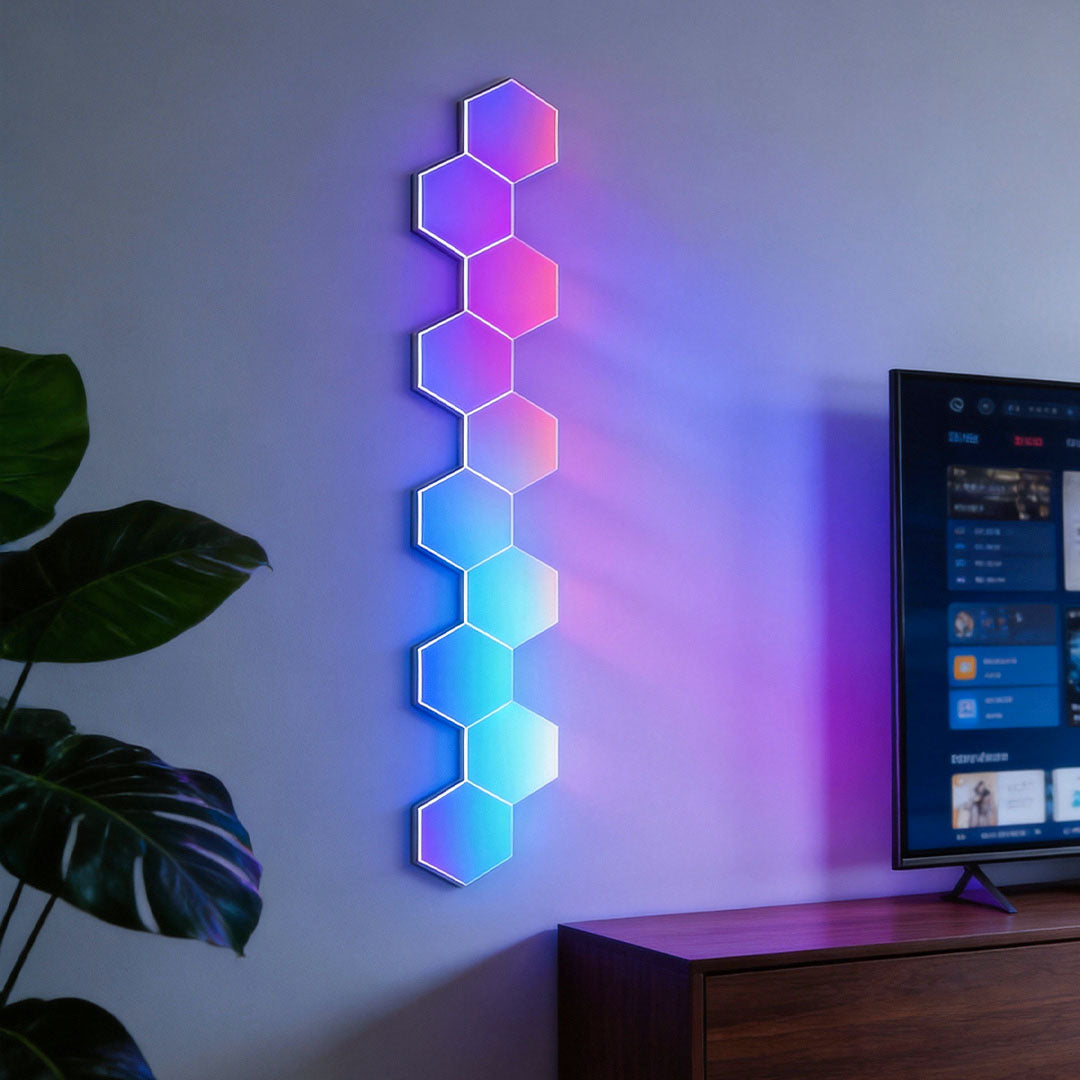 Hexagon LED wall lights arranged vertically on a wall, displaying colorful gradient effects in a minimalist interior.